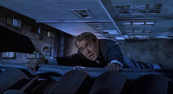 vertigo-movie-jimmy-stewart-hanging-on-rooftop-scottie