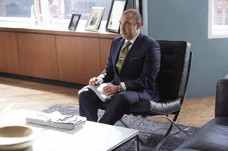 Suits: Louis Litt in a black leather Barcelona Chair