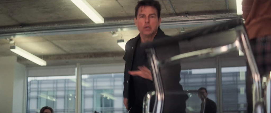 Tom Cruise reaches for the Eames office/management chair in Nero Netweave (black mesh)