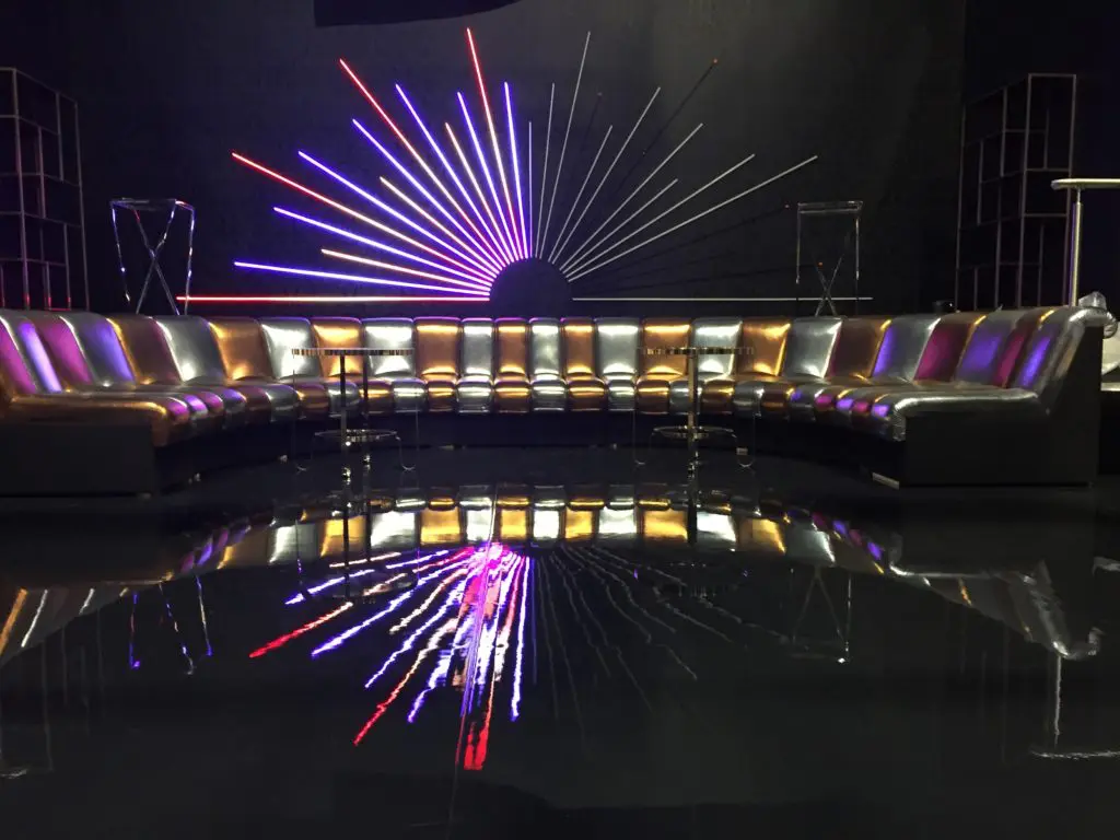 The Studio 54 filmset features a silver and gold sofa similar to a De Sede Non Stop sofa