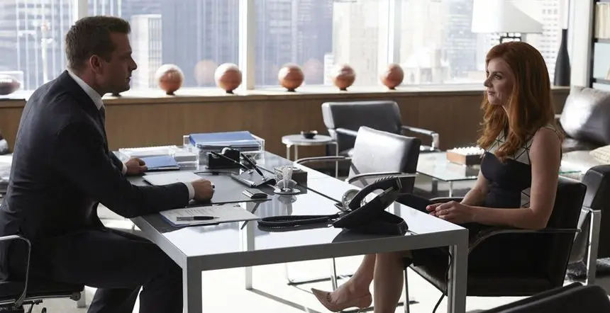 Donna sits in Brno chairs in Harvey's office in Suits