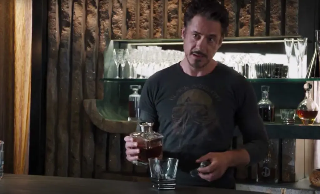 Tony Stark pours himself a whiskey in The Avengers