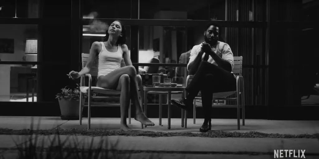 Malcolm and Marie - exterior sitting in outdoor chairs