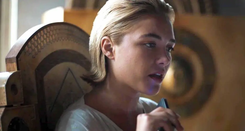 Princess Irulan (Florence Pugh) sits at a desk in a Bugatti-style chair