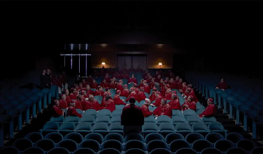 a lecture theatre with clergy from the film conclave showing the production design