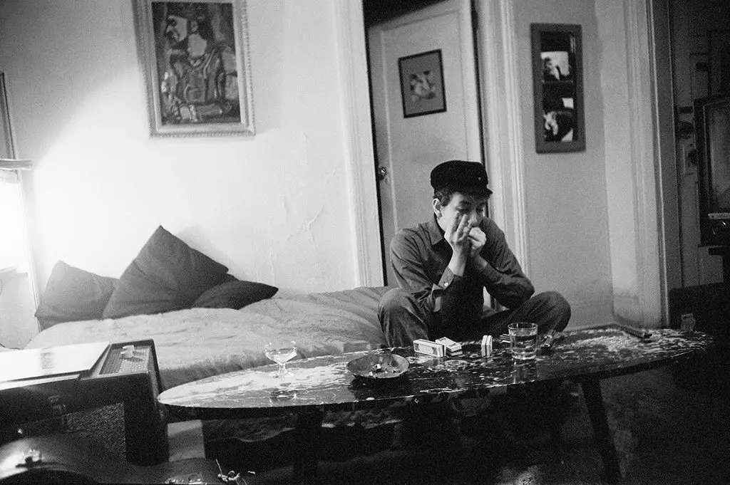Bob Dylan in his apartment in the early 1960s with coffee table he made himself. Photo by Ted Russell by permission of Francois Audouy