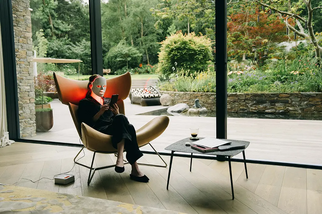 emma stone as michelle sitting in a chair in the filmset of Bugonia