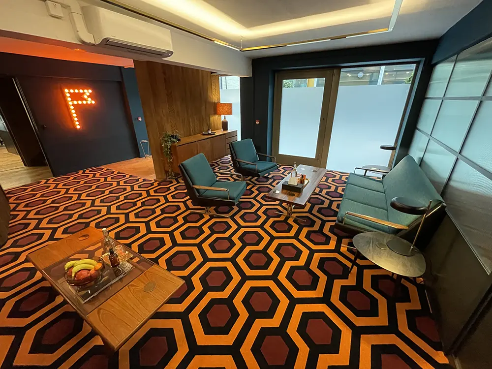 Hicks Hexagon printed nylon wall-to-wall fitted carpet in the reception area and meeting zone of Creative Outpost in London