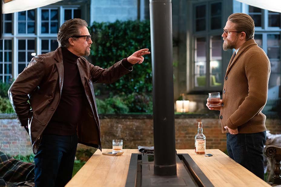 Fletcher and Ray enjoy a whiksy around the outdoor BBQ grill table in The Gentlemen