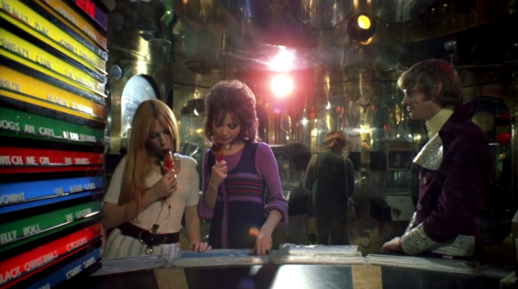 Alex spots the girls sucking on phallic lollies at the booth in the record store in A Clockwork Orange