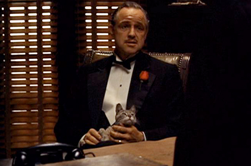 Model of Vito Corleone with cat in the famous chair from The Godfather