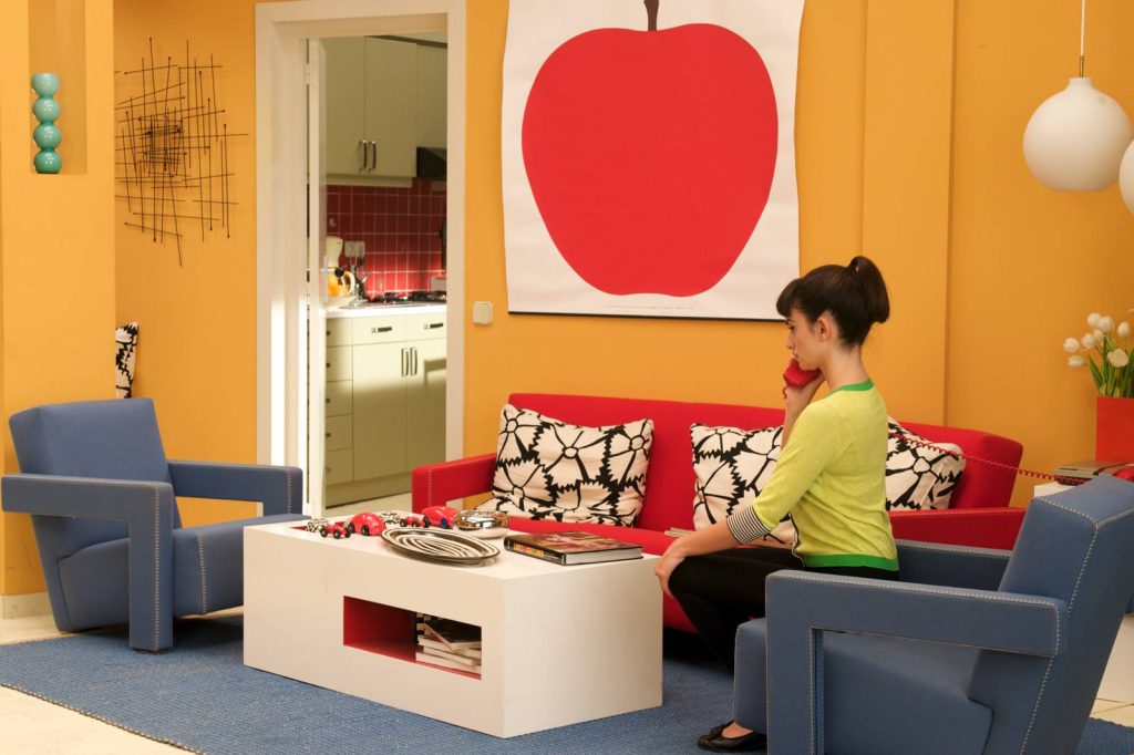 Almodovar's Broken Embraces featuring Enzo Mari's poster apple and two chairs