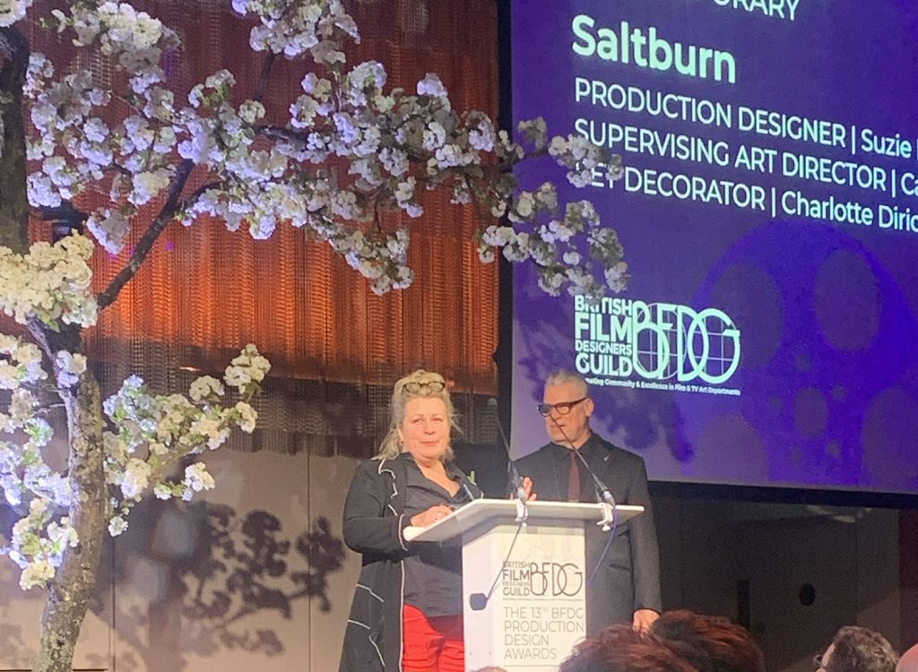 Production Designer Suzie Davis collects the award on behalf of the Saltburn team at the British Film Designers Guild Awards